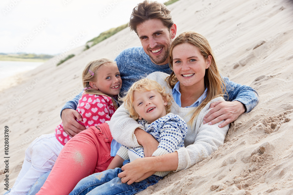 Portrait Of Family Lying In Sand Dunes Together Portrait Of Family Lying In Sand Dunes Together