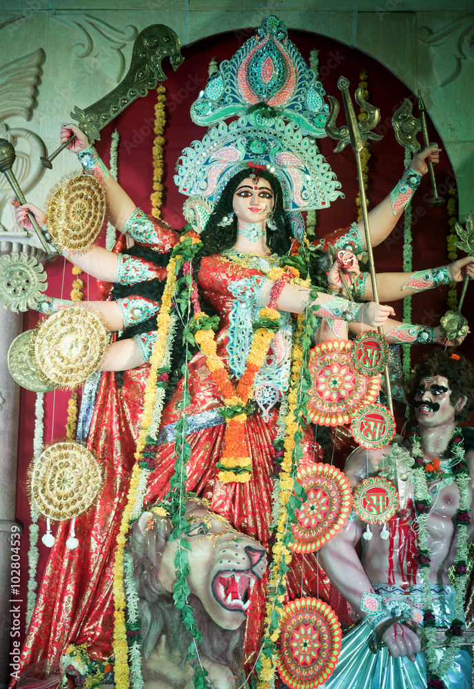 Obraz premium MUMBAI, INDIA - October 20, 2015: An idol of revered goddess Durga standing in the temporary temple in the city of Mumbai during Durga Puja festival celebration.