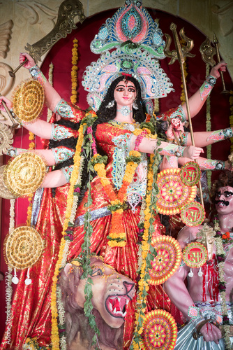 MUMBAI, INDIA - October 20, 2015: An idol of revered goddess Durga standing in the temporary temple in the city of Mumbai during Durga Puja festival celebration. © Tukaram karve