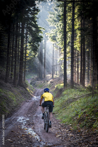 Young biker on muddy road