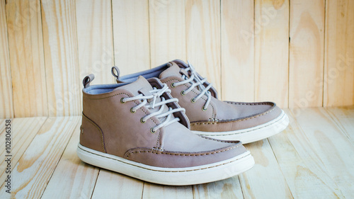 gray Suede Shoes on wooden background