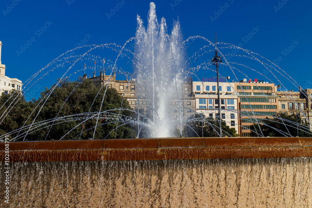 Fototapeta premium Barcelona, Catalunya, Spain - August 28, 2015: Plaza Catalunya view with people on a sunny day. It's the most turistic place in city.