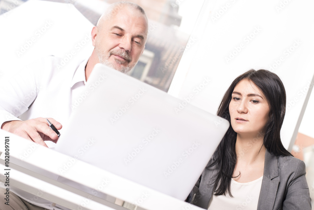 Business people interacting, discussing and sharing ideas in bright modern office. Focus on girl. Business people interacting, discussing and sharing ideas in bright modern office. Focus on girl.