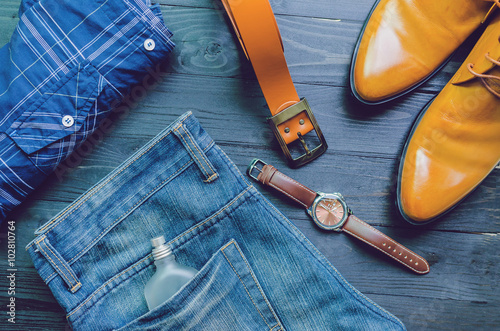 set of clothes and accessories on a wooden background