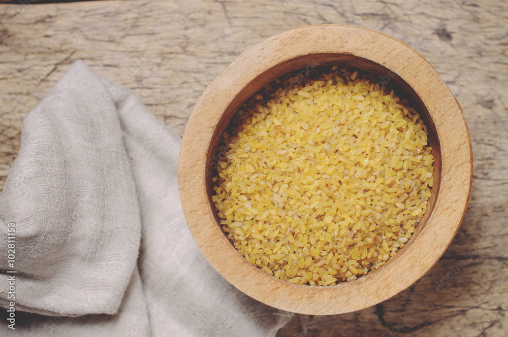 Raw Bulgur on wooden background Raw Bulgur on wooden background