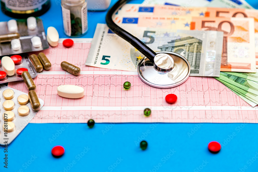 Stethoscope on cardiogram sheet with Euro bills and pills. Stethoscope on cardiogram sheet with Euro bills and pills.