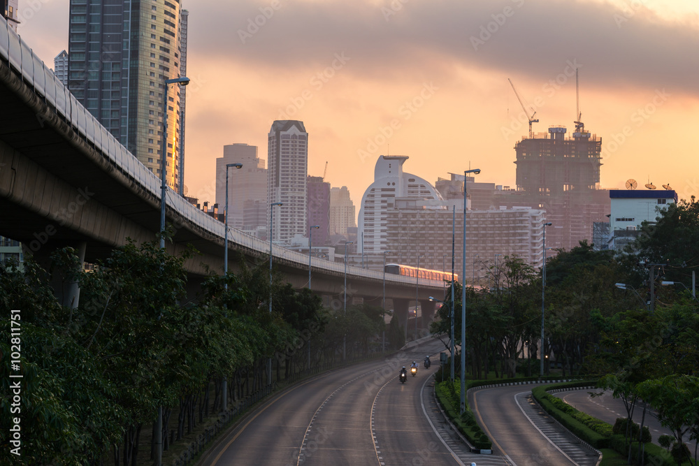 bangkok cityspace and speed train at sunrise

