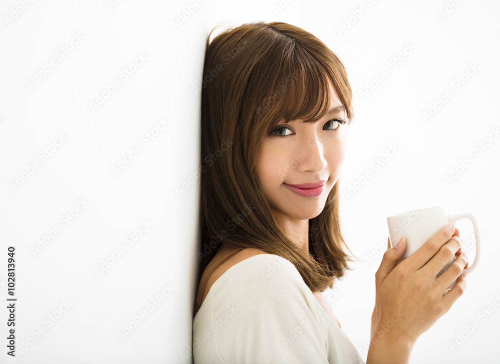 young Woman drinking hot latte coffee in living room young Woman drinking hot latte coffee in living room