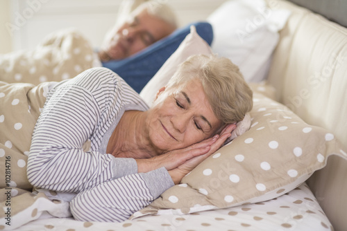 Woman and her husband sleeping comfortably . photo