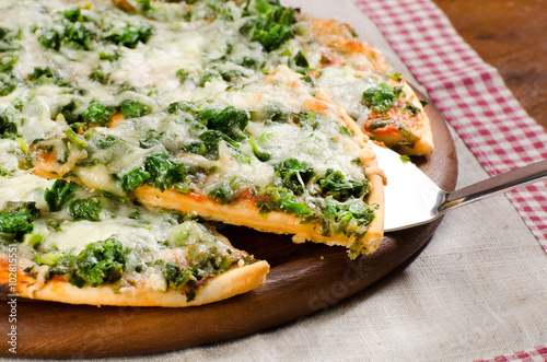 appetizing pizza with spinach and cheese cooked at home