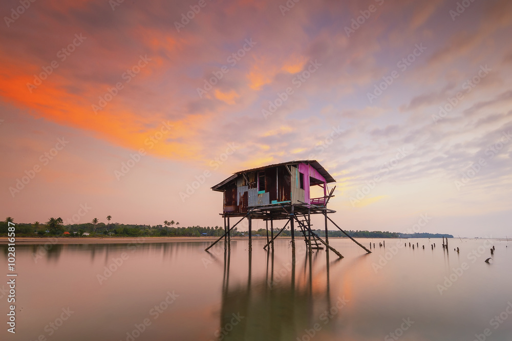 Abandoned floating house during a beautiful sunset