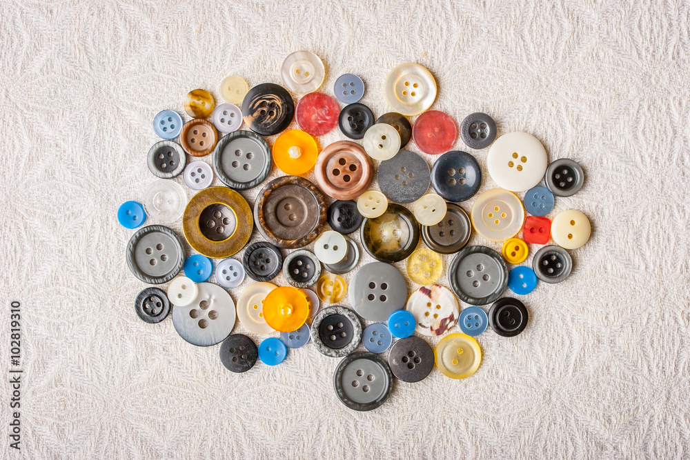 Buttons on the white fabric top view Buttons on the white fabric top view