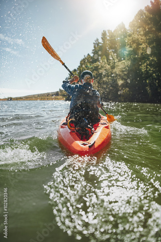 Mature man paddling a kayak