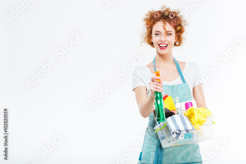 Housewife cleans with detergent spray