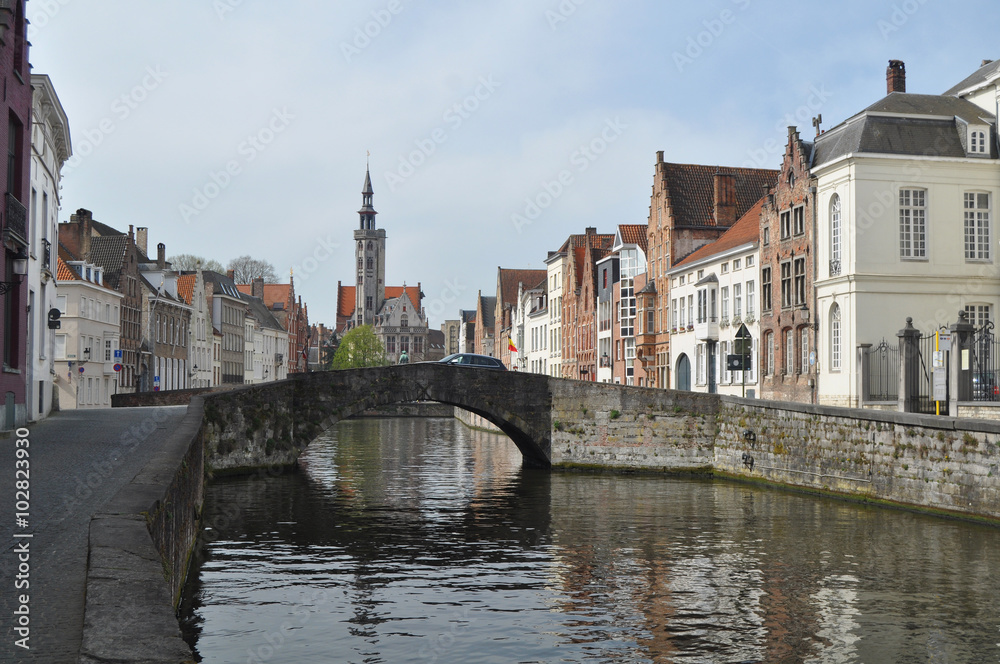 A panorama of picturesque Bruges in Belgium with the Zwin river a bridge and an old distinctive church in the background 