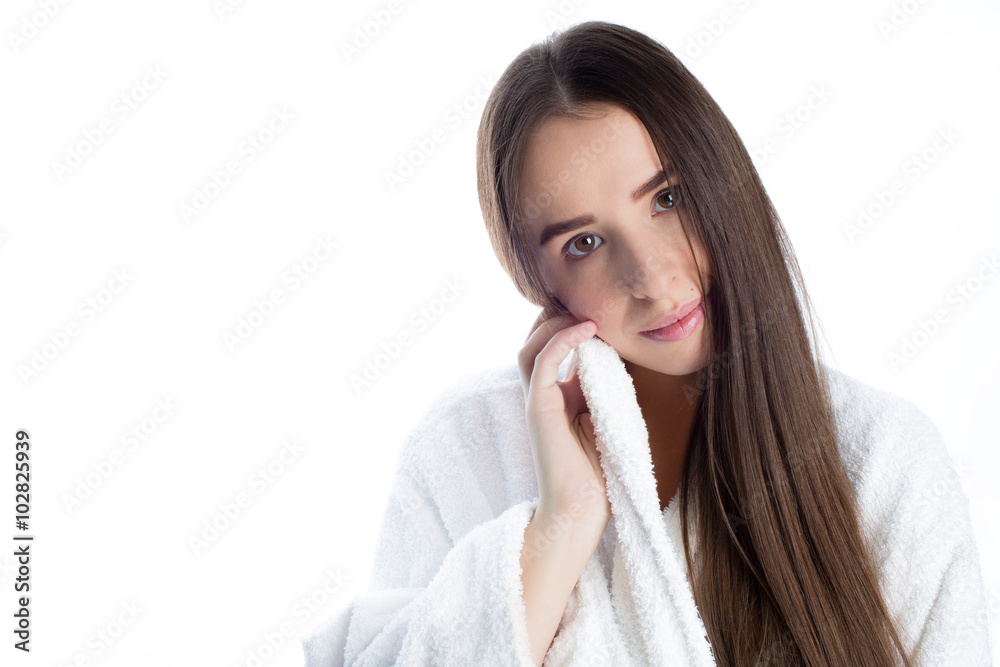 Tender young woman in white bathrobe after bathroom, studio white Tender young woman in white bathrobe after bathroom, studio white