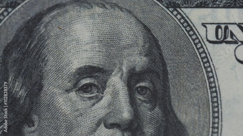 Macro close up slide shot of Ben Franklin's face on the US $100 dollar bill 1
