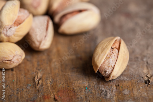 pistachios on wood background