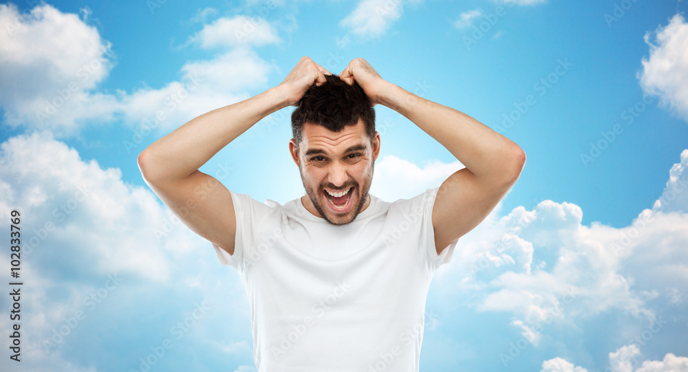 crazy shouting man in t-shirt over blue sky crazy shouting man in t-shirt over blue sky