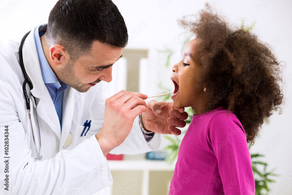 Pediatrician examining cute smiling african girl, throat sick Pediatrician examining cute smiling african girl, throat sick