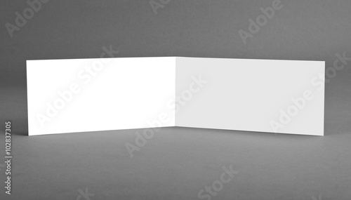White empty open card on grey to replace your design.