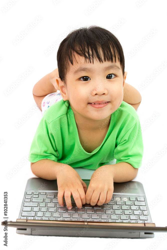 Chinese little girl lying down with laptop Chinese little girl lying down with laptop