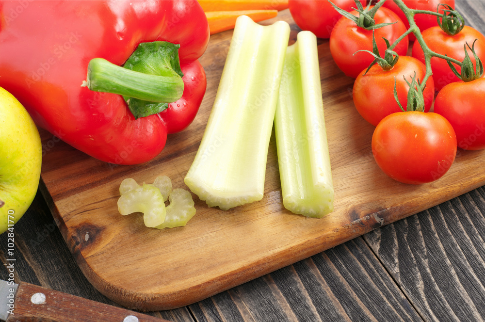 Celery sticks with red peppers, carrots, tomatoes and apples Celery sticks with red peppers, carrots, tomatoes and apples