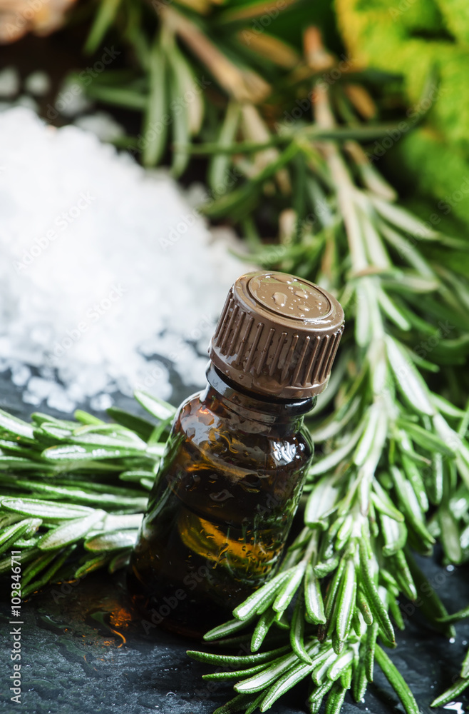 Rosemary essential oil Spa composition with sea salt, candles, t Rosemary essential oil Spa composition with sea salt, candles, t