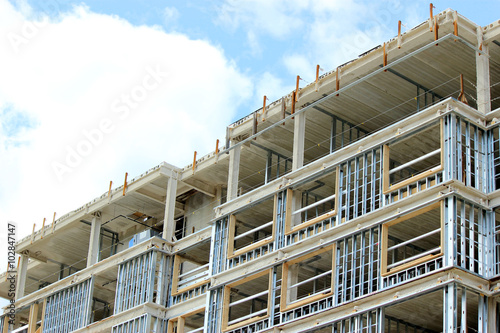 Contruction site of residential building on blue sky background