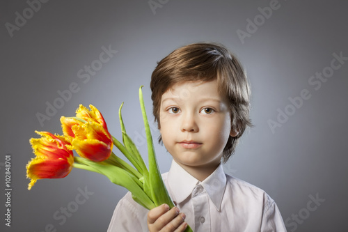 cheerful kid with a bouquet of tulips