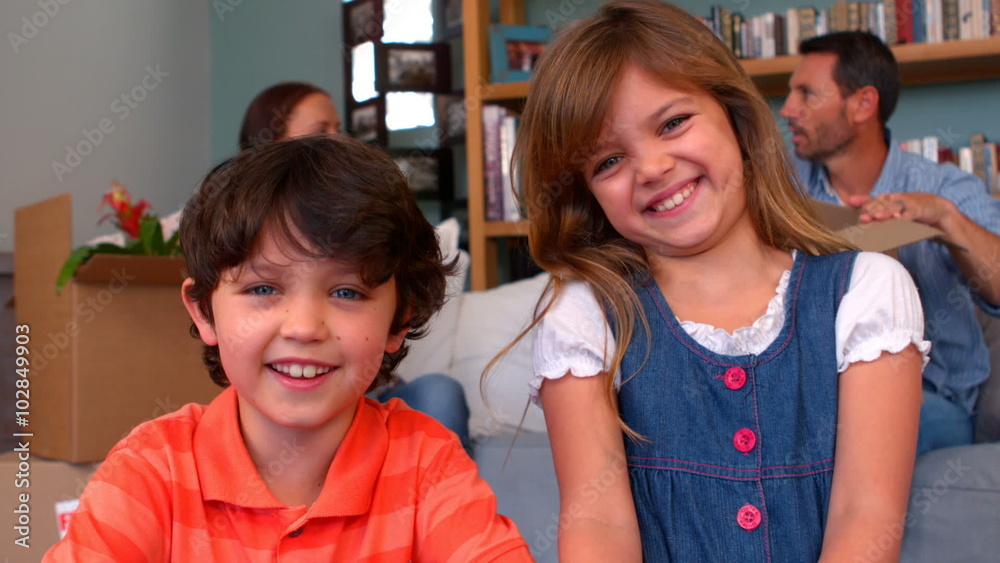 Smiling sibling unpacking boxes Smiling sibling unpacking boxes
