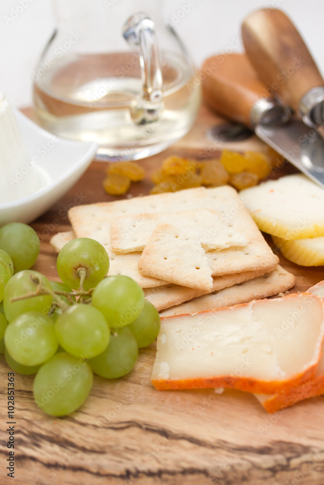 cheese with cookies, grapes and white wine