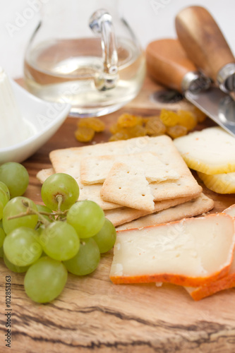 cheese with cookies, grapes and white wine