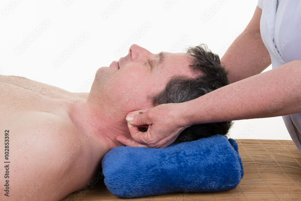 Mature male receiving ear reflexology massage of both ears at the same time. Mature male receiving ear reflexology massage of both ears at the same time.