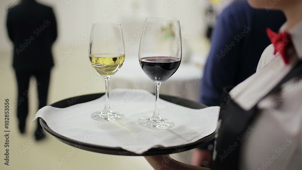 waiter holding a tray with glasses of wine