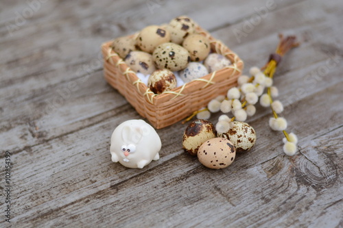 White Easter bunny and guail egg close-up photo