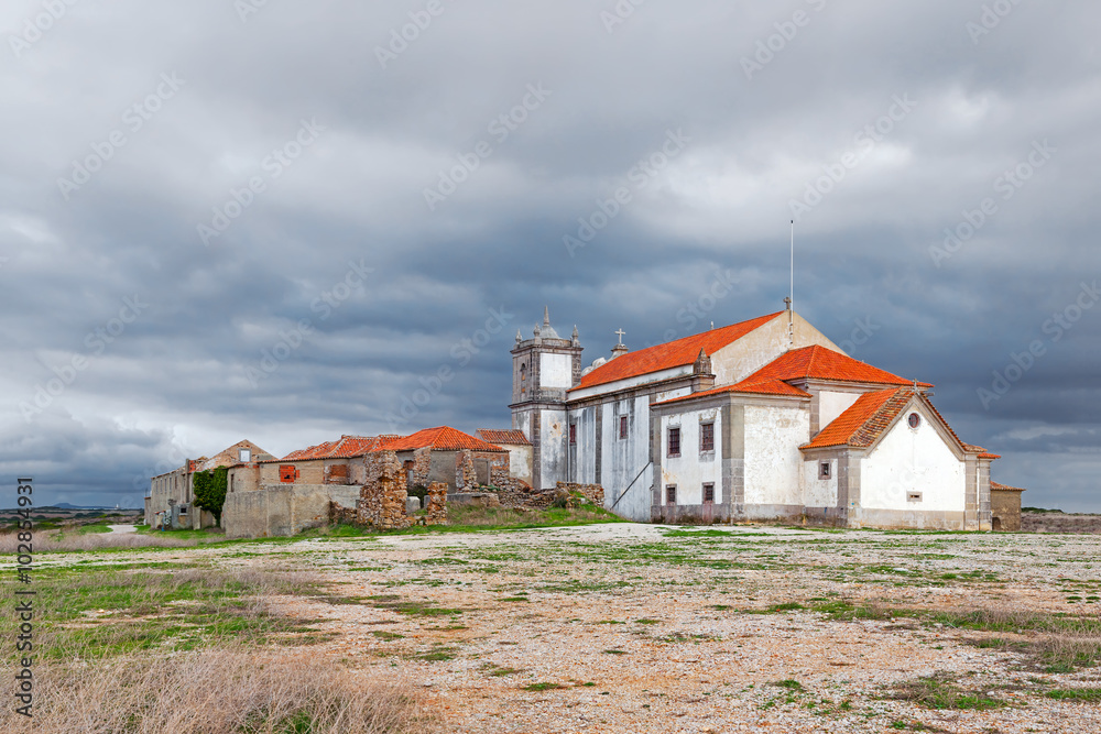 Back of the baroque church in the Sanctuary of Nossa Senhora do Cabo, aka Nossa Senhora da Pedra Mua, with ruins. Espichel Cape. Sesimbra, Portugal