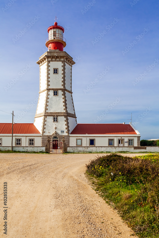 The Espichel Cape lighthouse, built during the 18th century is one of the oldest lighthouses in Portugal and guides boats and ships navigating in the Atlantic Ocean. Sesimbra, Portugal.