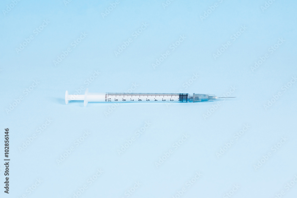 Syringe on a blue background Syringe on a blue background