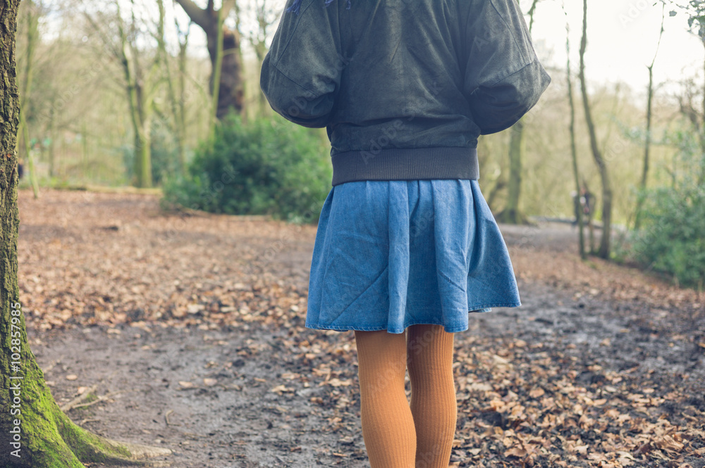 Woman walking in forest on autumn day Woman walking in forest on autumn day