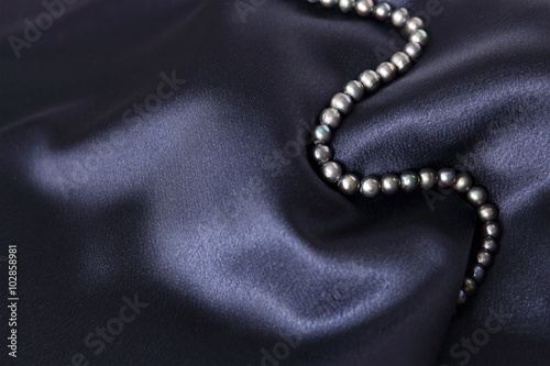 necklace black pearl  on a dark blue background