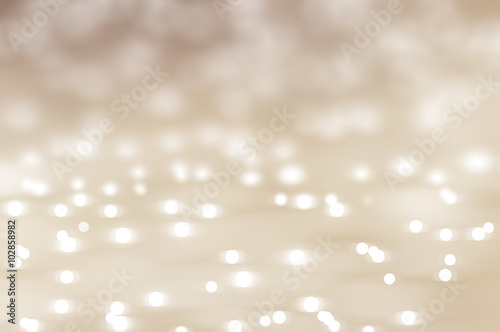 Bokeh light, shimmering blur spot lights on beige abstract