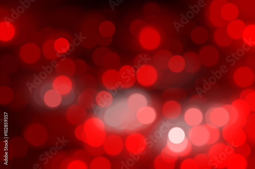 Bokeh light, shimmering blur spot lights on red abstract 
