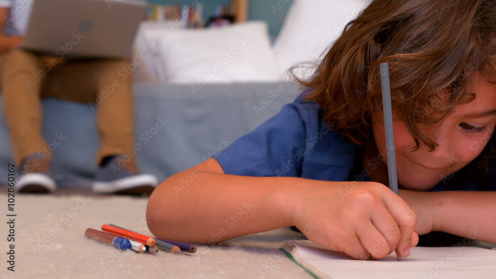 Son drawing while lying on the floor Son drawing while lying on the floor