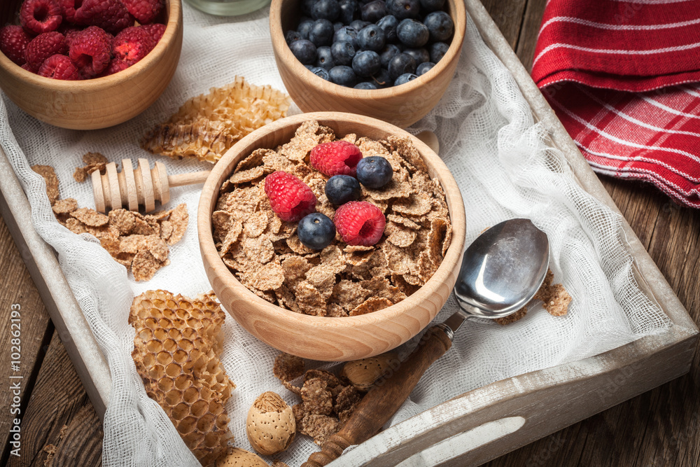 Bowl of cereals with blueberries and raspberrie. Bowl of cereals with blueberries and raspberrie.