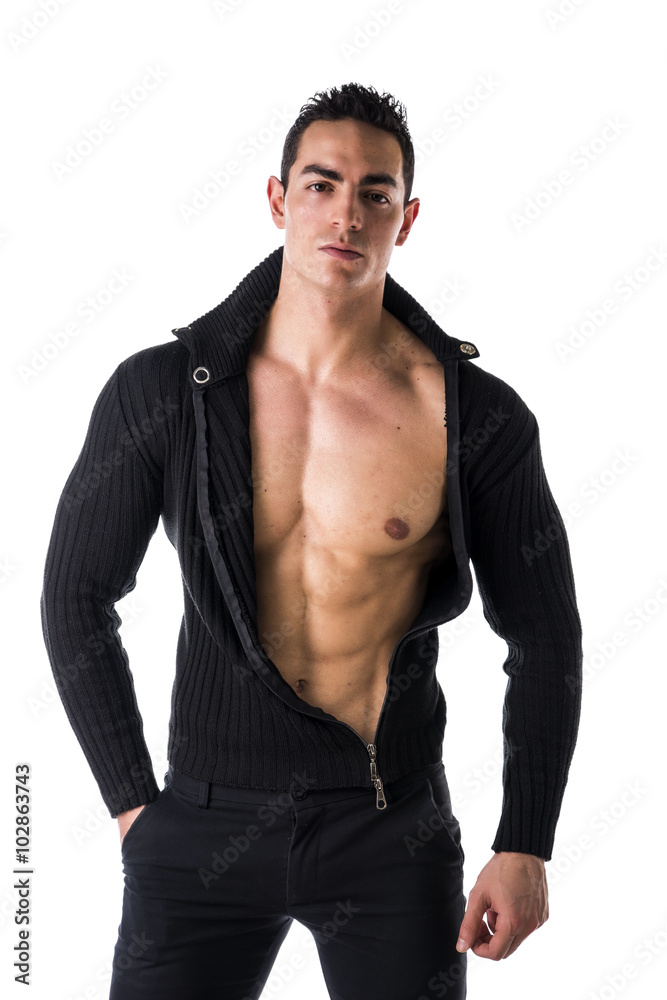 Handsome muscular young man taking off shirt Handsome muscular young man taking off shirt