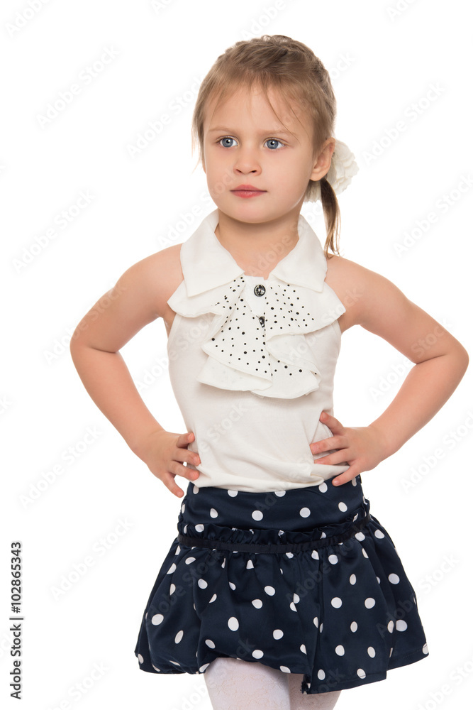 Serious little girl hands on hips. Closeup - Isolated on white background Serious little girl hands on hips. Closeup - Isolated on white background