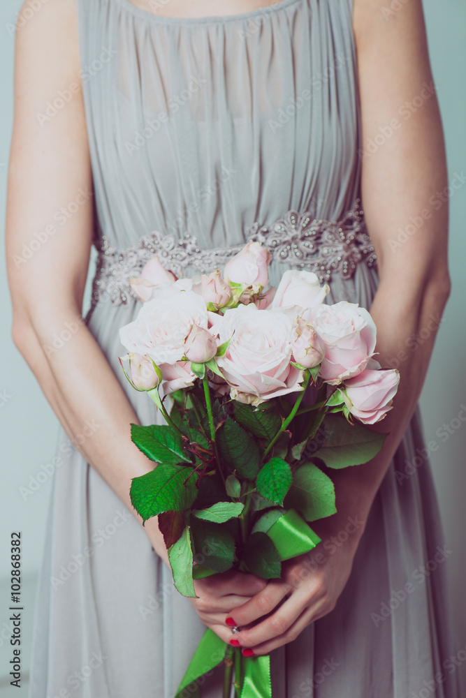 Wedding bouquet of flowers, young bridesmaid holding a bouquet of pink roses.