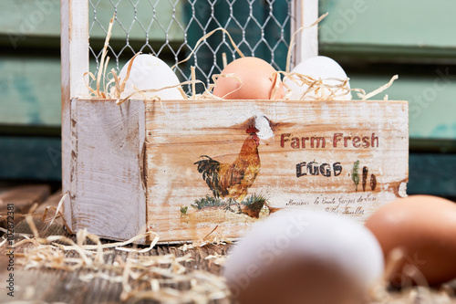 Fresh farm eggs in a wooden box