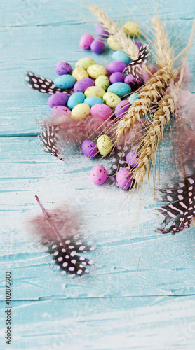 Easter colored eggs, feathers, blue wooden © wilddrago